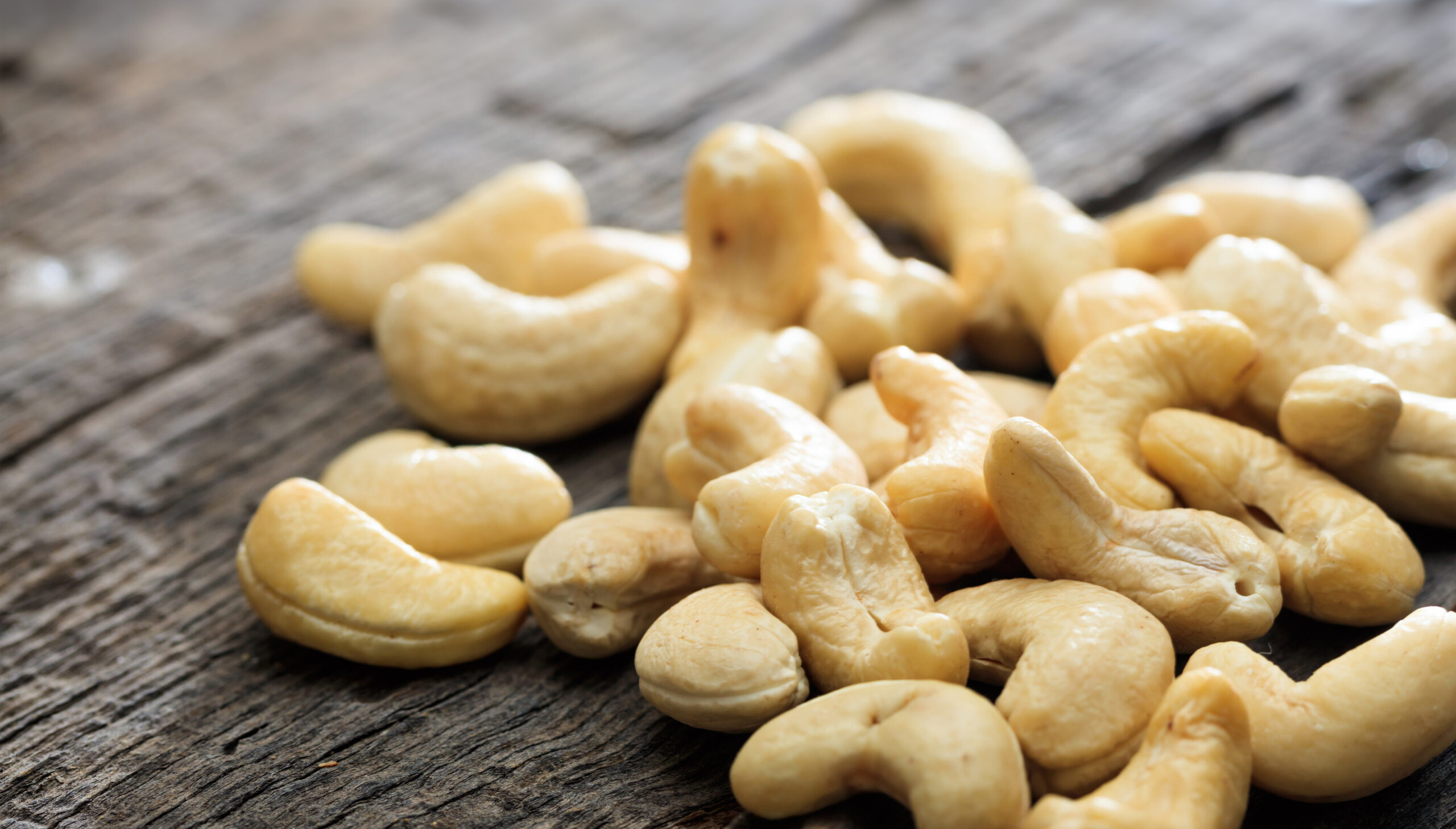 Cashews on an old wooden table, copy space